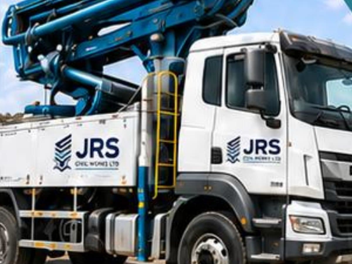 A JRS-branded truck-mounted concrete pump with its boom folded over the chassis.