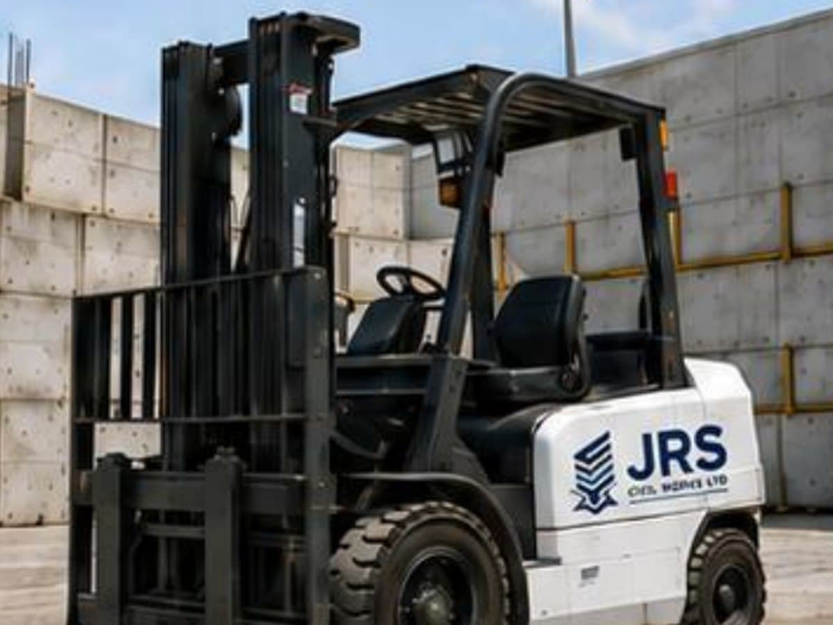 A JRS-branded counterbalance forklift beside precast concrete panels.