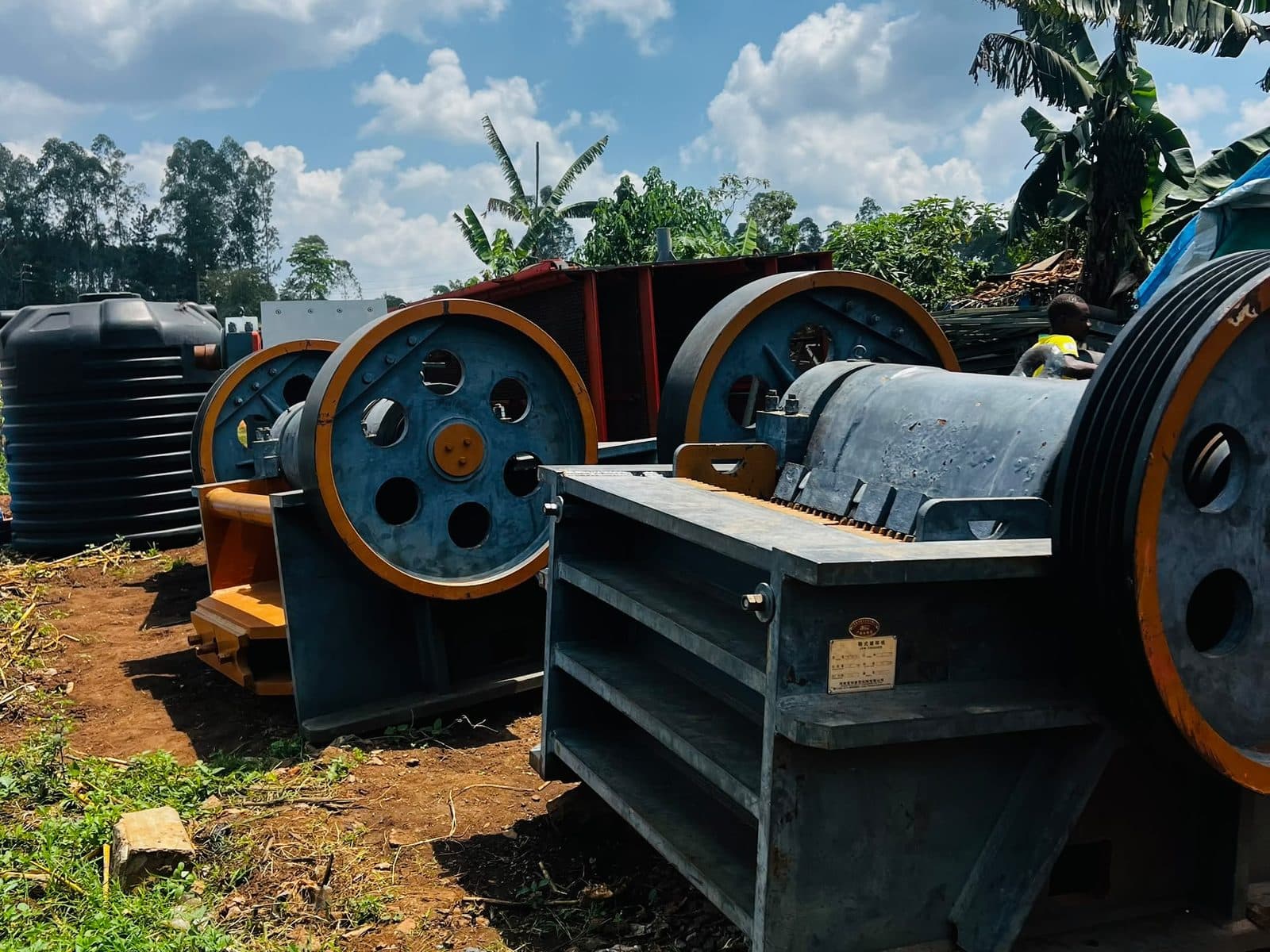 Two jaw crusher units standing on site, with flywheels and feed openings visible.