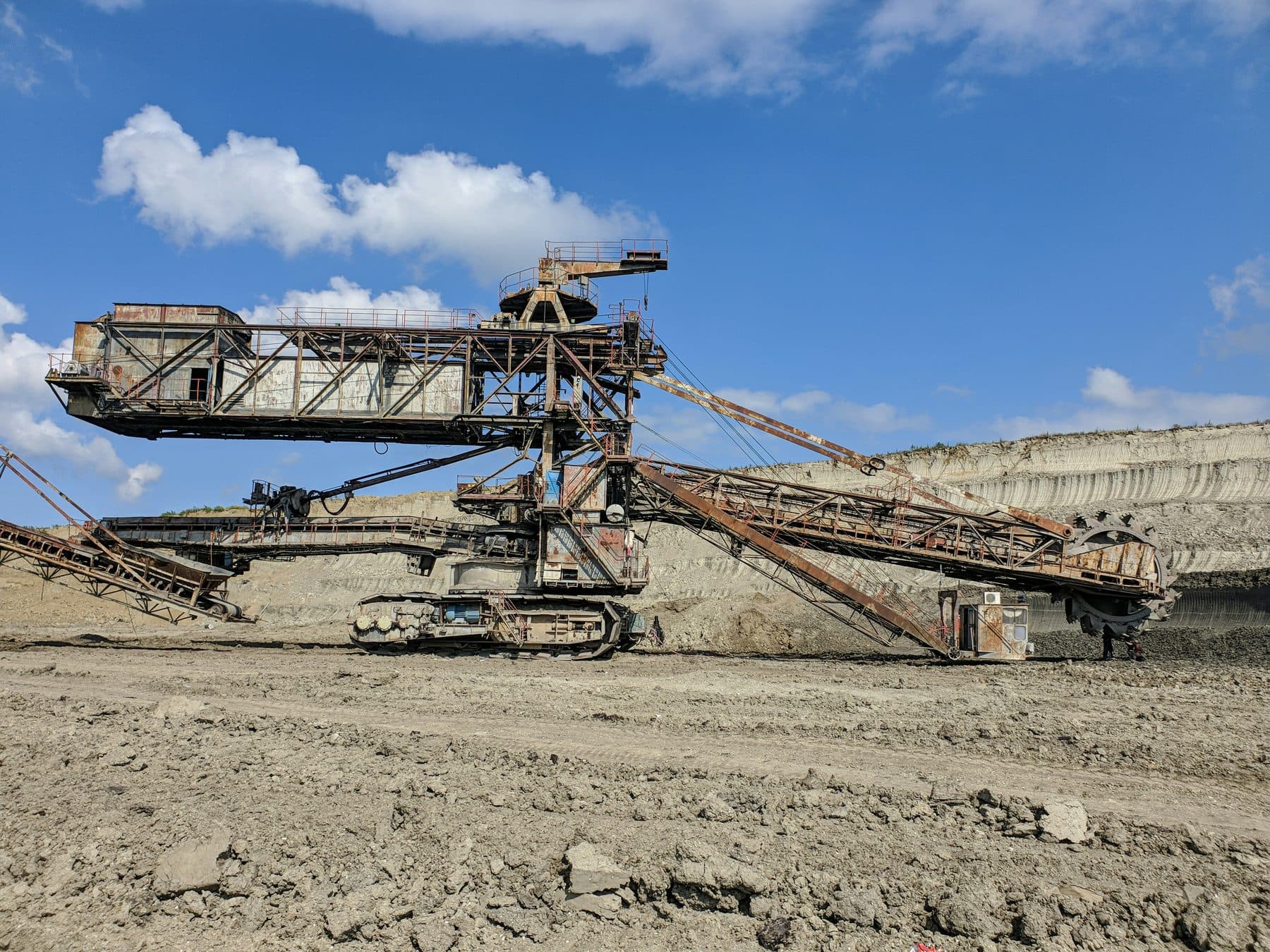 A large crushing machine working over a bed of quarried stone.